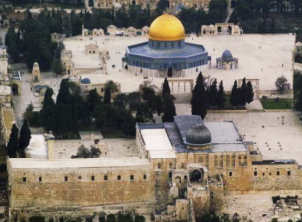 Aerial view of Jerusalem's Temple Mount with the golden-domed Dome of the Rock on a large stone plaza, the adjacent Al-Aqsa Mosque in the foreground, surrounding ancient walls and cypress trees.